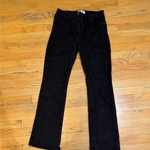 Women’s Black flare jeans with slit on the bottom.